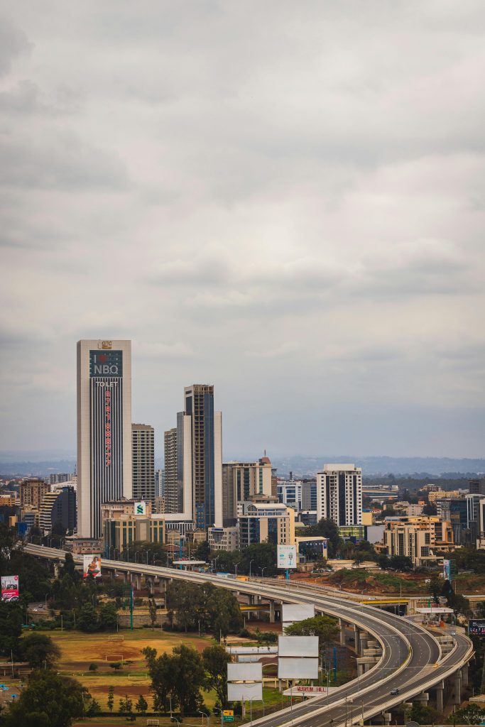Aerial cityscape of Nairobi, Kenya showcasing skyscrapers and highways under an overcast sky.