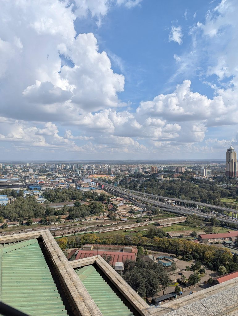 Aerial view of Nairobi skyline with clouds and cityscape, showcasing urban beauty.